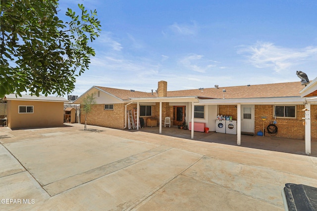 316 Garden Grove Ln, El Paso, TX 79912 - back of property with brick siding, washer and dryer, and a patio area