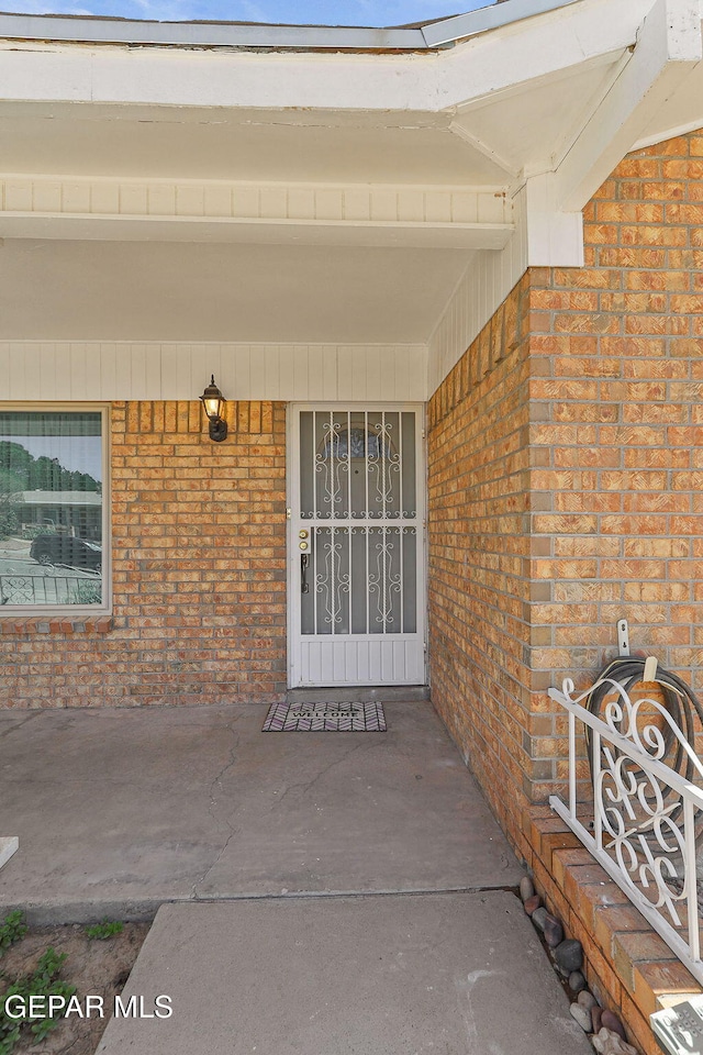 316 Garden Grove Ln, El Paso, TX 79912 - view of exterior entry with covered porch and brick siding