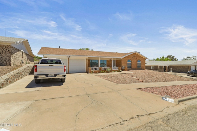 316 Garden Grove Ln, El Paso, TX 79912 - ranch-style house with brick siding, a porch, concrete driveway, and an attached garage