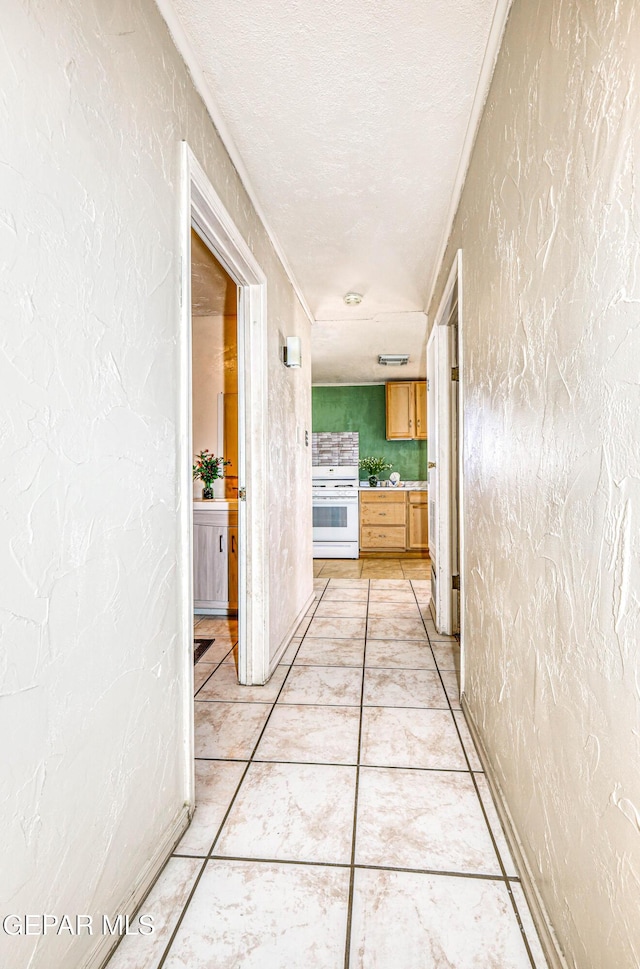 11144 Perlette St, Socorro, TX 79927 - hall featuring light tile patterned flooring, a textured ceiling, and a textured wall
