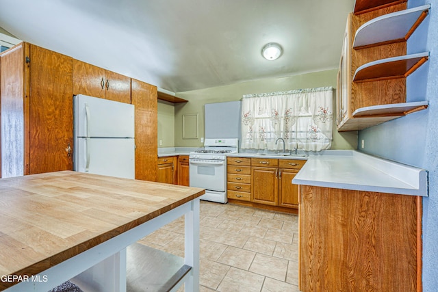 11144 Perlette St, Socorro, TX 79927 - kitchen with brown cabinets, white appliances, open shelves, and a sink