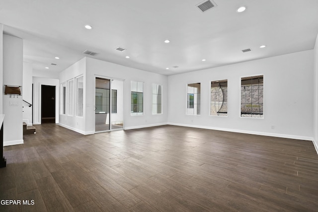 unfurnished living room with visible vents, recessed lighting, and dark wood finished floors