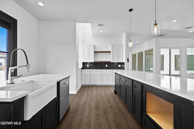 kitchen with open shelves, a sink, visible vents, dishwasher, and dark cabinetry