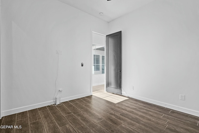 unfurnished room featuring ceiling fan, wood finished floors, and baseboards