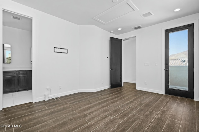 interior space featuring visible vents, wood finished floors, and baseboards