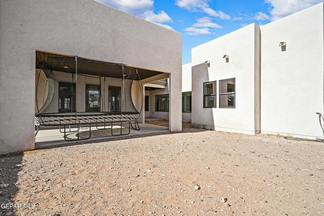 back of property featuring stucco siding and a patio area