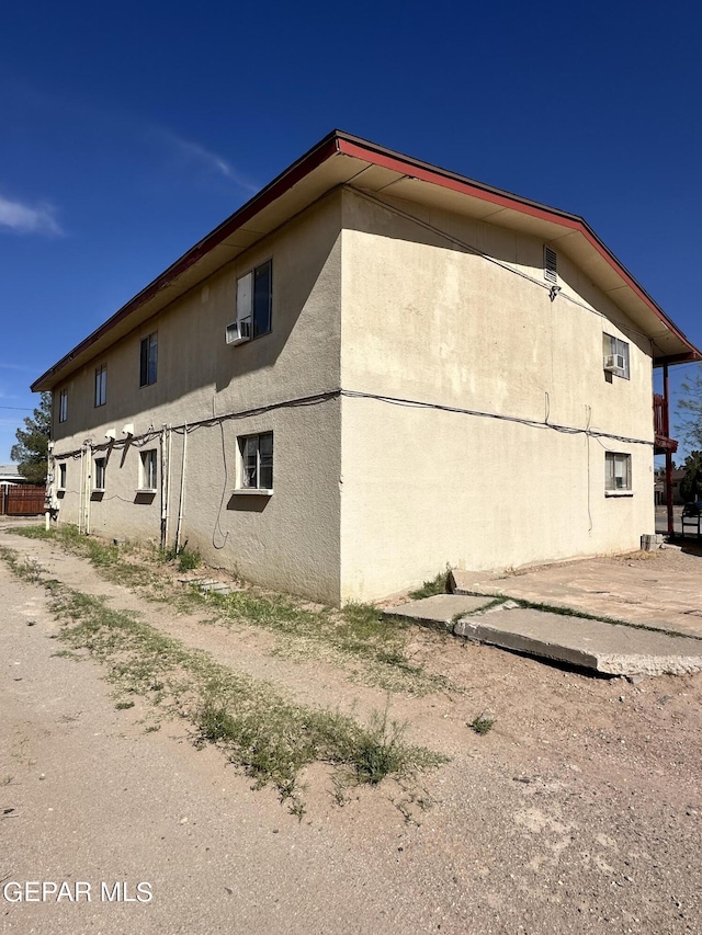 view of side of property with stucco siding