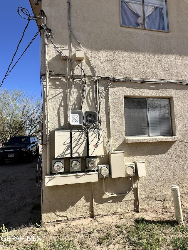view of side of property with stucco siding
