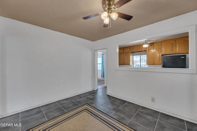 1003 Alethea Park Dr, El Paso, TX 79902 - unfurnished room featuring dark tile patterned floors and ceiling fan