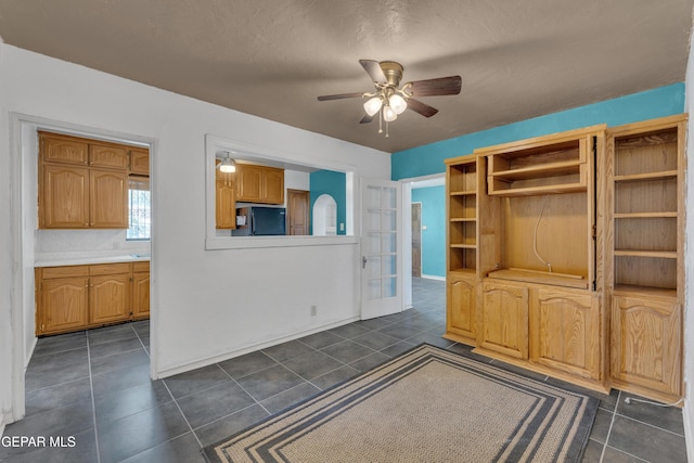 1003 Alethea Park Dr, El Paso, TX 79902 - interior space featuring baseboards, ceiling fan, and dark tile patterned flooring