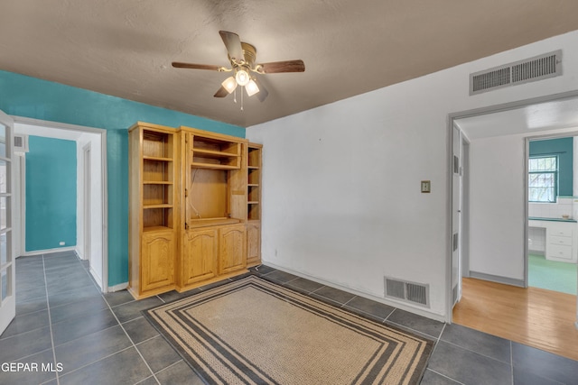 1003 Alethea Park Dr, El Paso, TX 79902 - interior space featuring visible vents, baseboards, ceiling fan, and dark tile patterned flooring