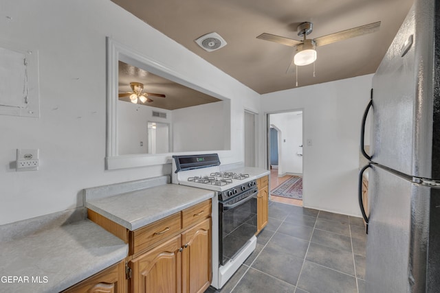 1003 Alethea Park Dr, El Paso, TX 79902 - kitchen featuring ceiling fan, gas stove, light countertops, freestanding refrigerator, and visible vents