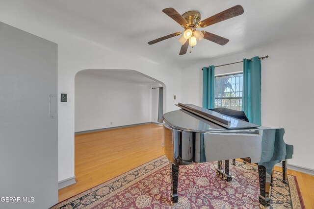 1003 Alethea Park Dr, El Paso, TX 79902 - living area with arched walkways, a ceiling fan, and wood finished floors