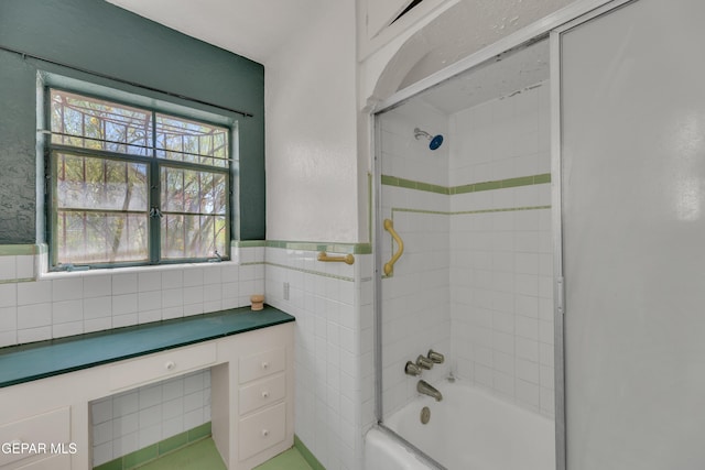 1003 Alethea Park Dr, El Paso, TX 79902 - bathroom featuring tile walls, a wainscoted wall, and bathtub / shower combination