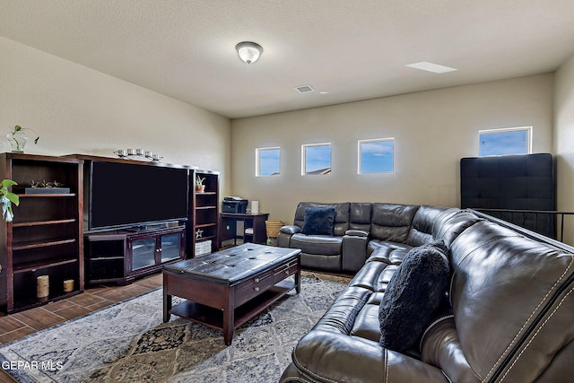 living area with wood finished floors and visible vents