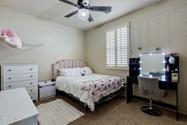 bedroom with a ceiling fan and carpet