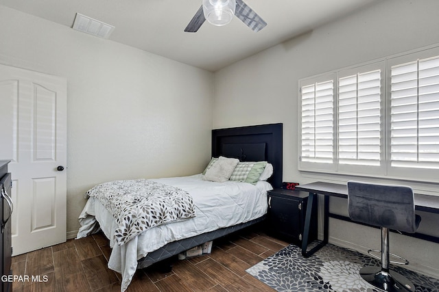 bedroom with a ceiling fan, visible vents, and wood finished floors