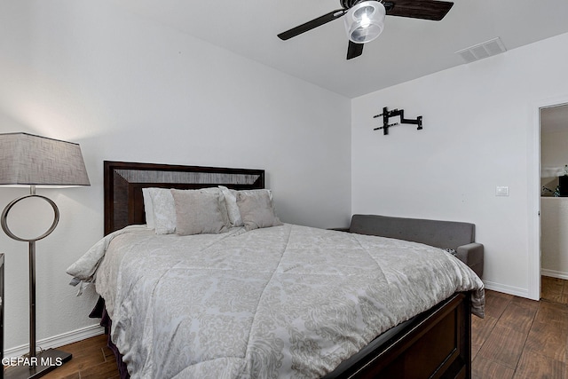 bedroom with visible vents, baseboards, ceiling fan, and dark wood-type flooring