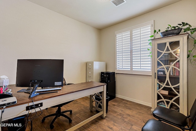 office area featuring visible vents, wood finished floors, and baseboards