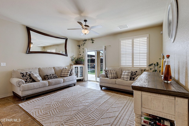 living area featuring ceiling fan and visible vents