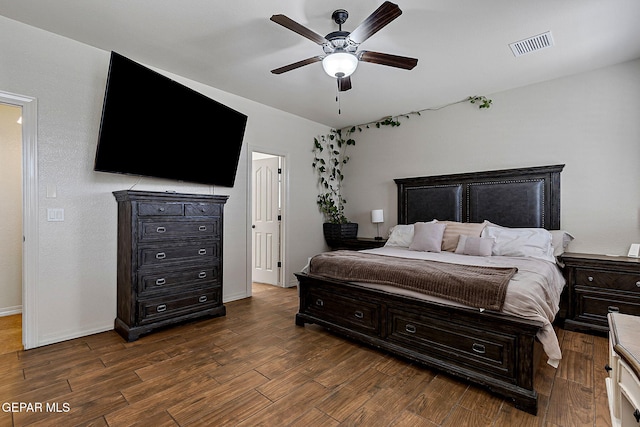 bedroom with visible vents, ceiling fan, and dark wood finished floors