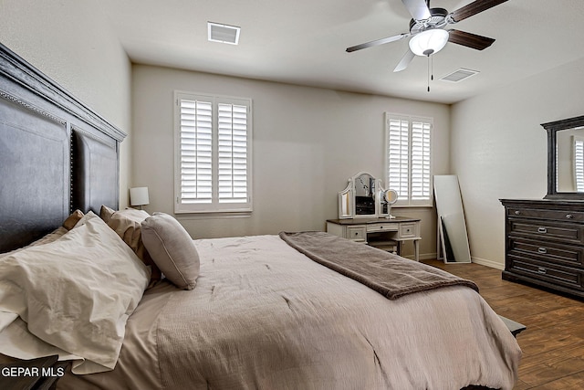 bedroom featuring baseboards, visible vents, ceiling fan, and dark wood-type flooring