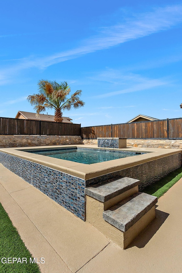 view of pool with a fenced backyard, a hot tub, and a fenced in pool