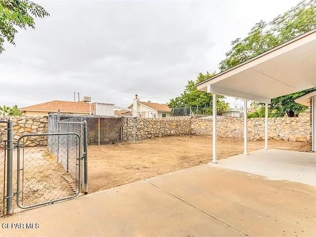 exterior space featuring a patio, a gate, and fence