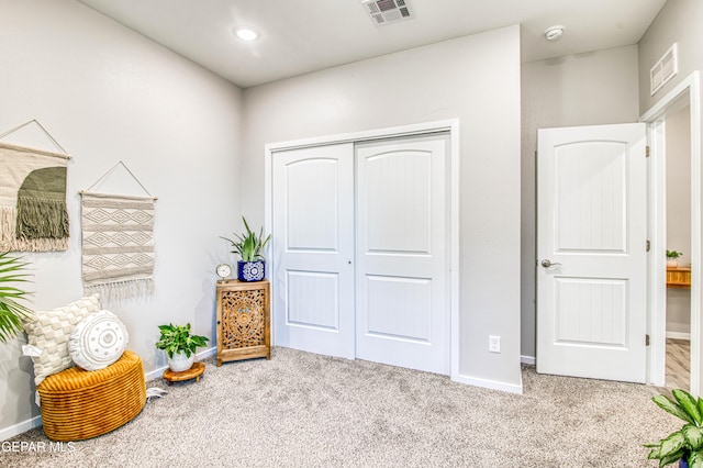 sitting room featuring baseboards, carpet, and visible vents