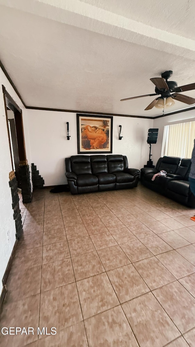 living room with light tile patterned flooring, a ceiling fan, and a textured ceiling