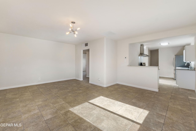 unfurnished living room with baseboards, visible vents, and a notable chandelier