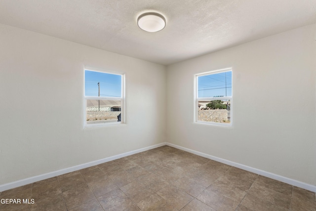 empty room featuring baseboards