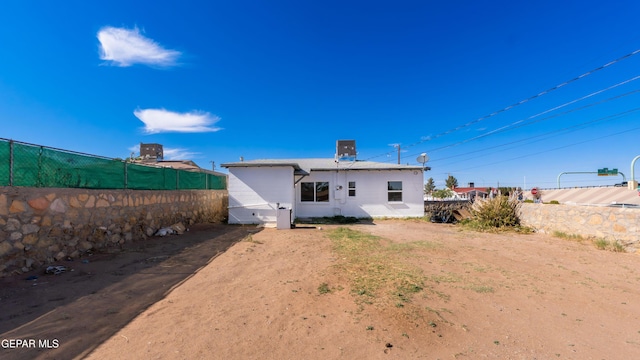 rear view of property with fence