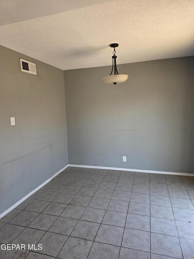 5001 Winthrop Dr, El Paso, TX 79924 - unfurnished room featuring a textured ceiling, tile patterned floors, and baseboards