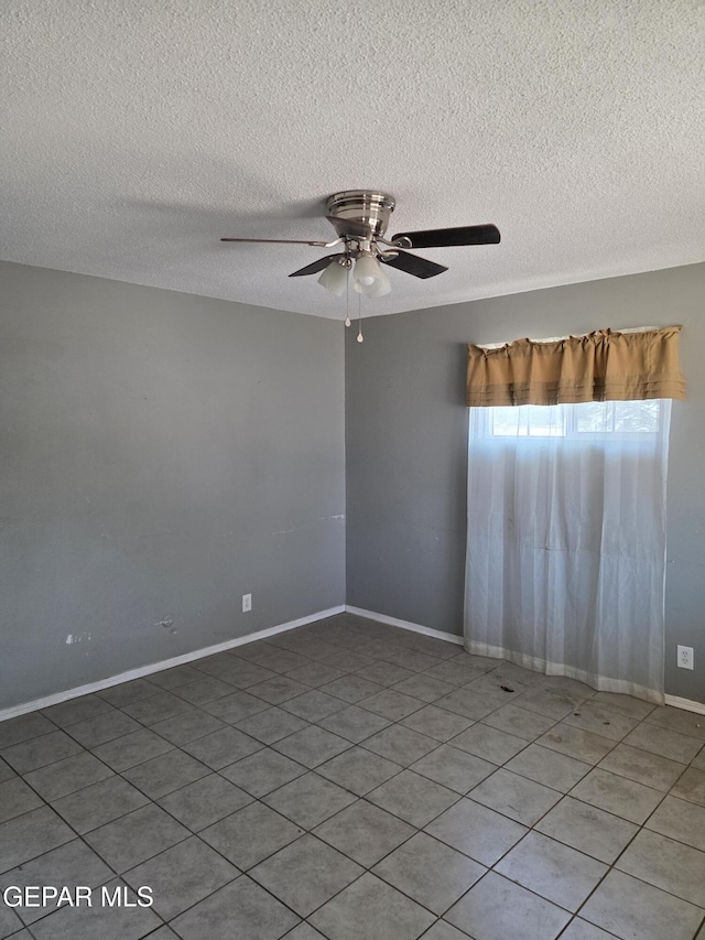 5001 Winthrop Dr, El Paso, TX 79924 - tiled spare room featuring a textured ceiling, a ceiling fan, and baseboards