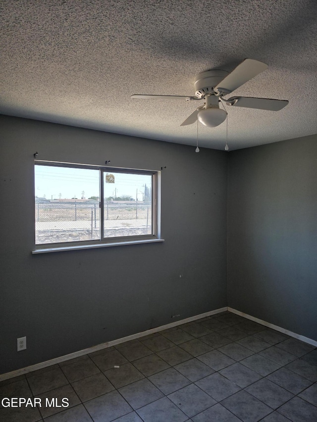 5001 Winthrop Dr, El Paso, TX 79924 - tiled empty room with ceiling fan, a textured ceiling, and baseboards