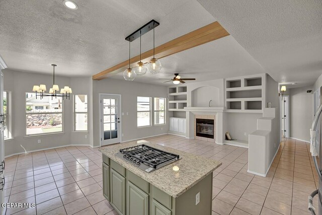 12617 Sun Spirit Dr, El Paso, TX 79938 - kitchen with green cabinetry, a textured ceiling, light tile patterned floors, a ceiling fan, and stainless steel gas cooktop