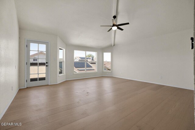 12617 Sun Spirit Dr, El Paso, TX 79938 - unfurnished living room featuring healthy amount of natural light, wood finished floors, ceiling fan, vaulted ceiling, and baseboards