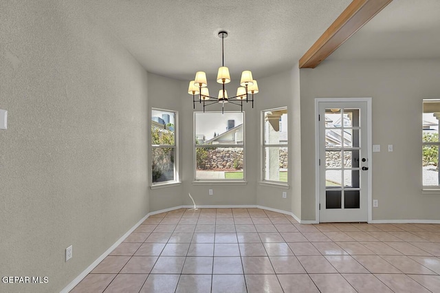 12617 Sun Spirit Dr, El Paso, TX 79938 - unfurnished dining area with a chandelier, a textured wall, light tile patterned flooring, a textured ceiling, and beamed ceiling