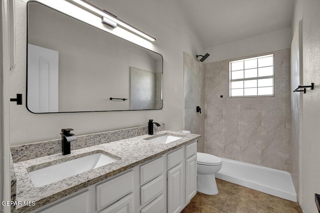 12617 Sun Spirit Dr, El Paso, TX 79938 - full bathroom with toilet, double vanity, a tile shower, and tile patterned flooring