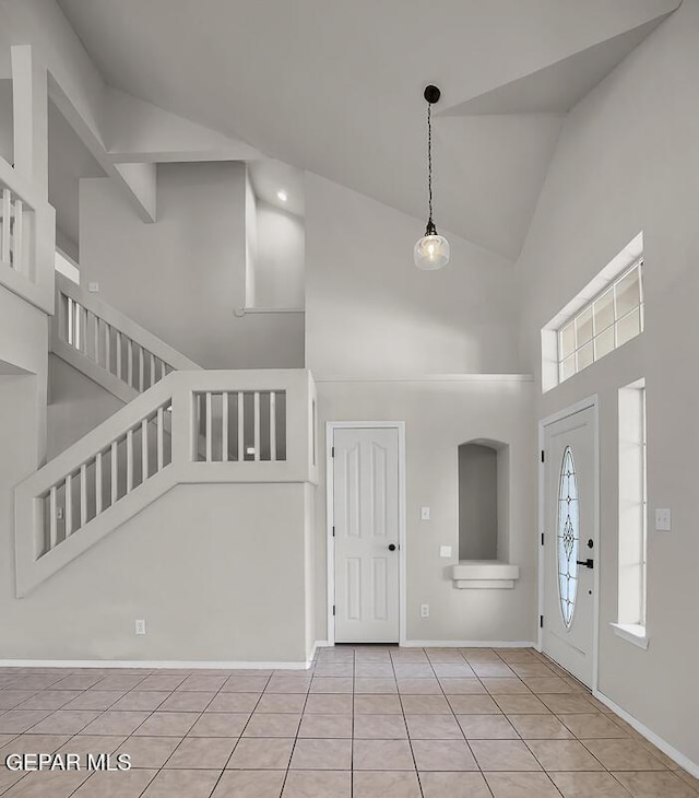 12617 Sun Spirit Dr, El Paso, TX 79938 - entrance foyer featuring high vaulted ceiling, light tile patterned floors, baseboards, and stairs