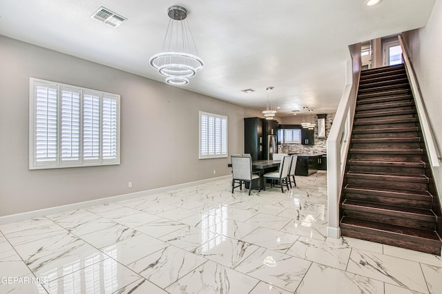 interior space featuring baseboards, recessed lighting, a chandelier, and visible vents
