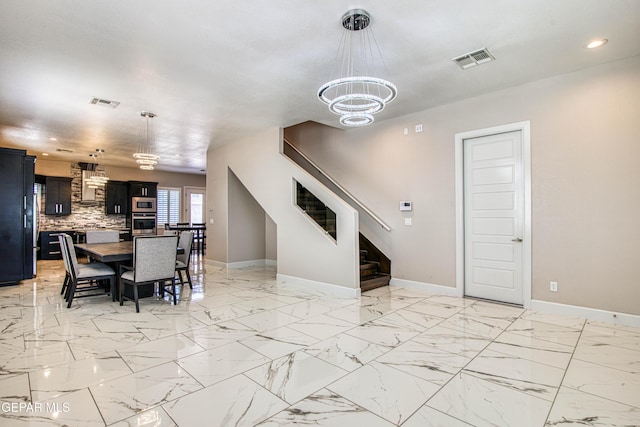 dining room featuring a chandelier, baseboards, visible vents, and recessed lighting