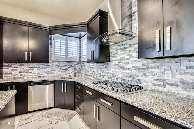 kitchen featuring backsplash, a sink, marble finish floor, stainless steel appliances, and wall chimney exhaust hood
