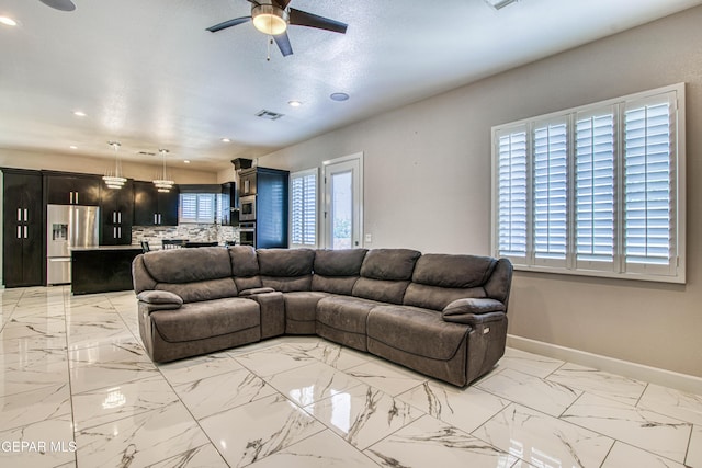 living area featuring a ceiling fan, visible vents, baseboards, marble finish floor, and recessed lighting
