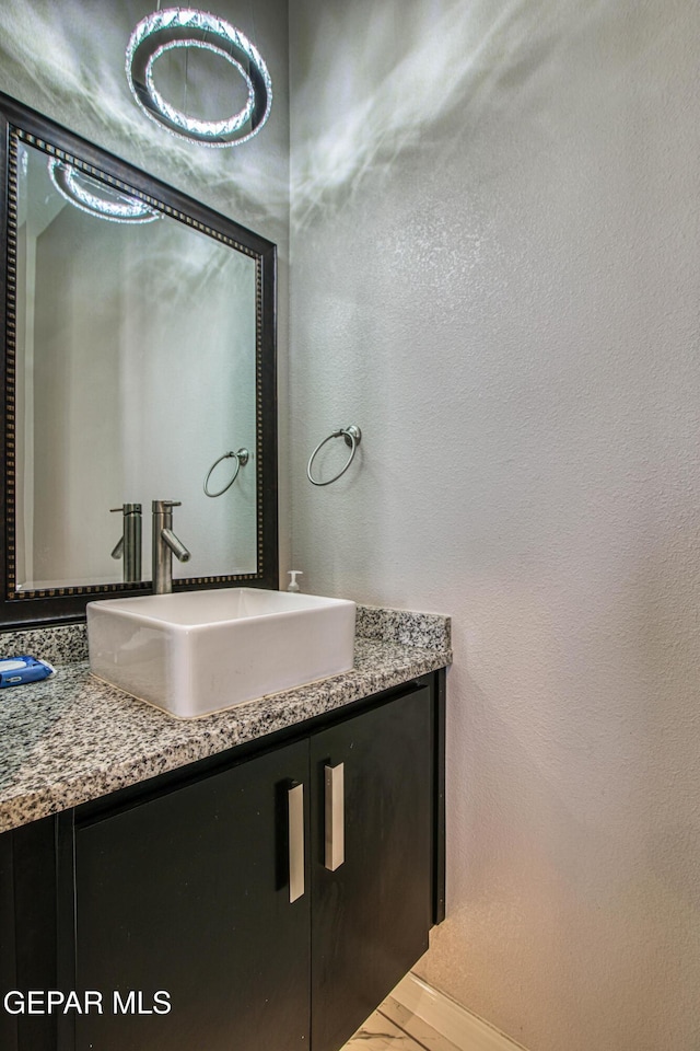 bathroom featuring baseboards and vanity