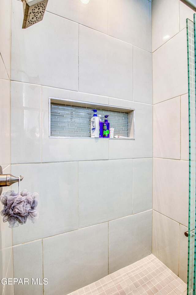 bathroom with tiled shower