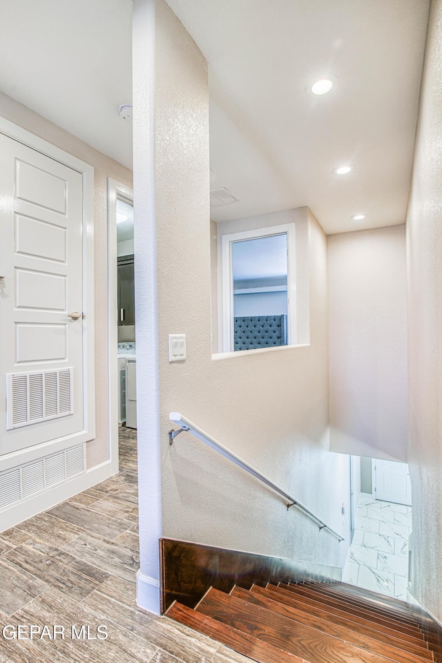 staircase with baseboards, recessed lighting, wood finished floors, and visible vents