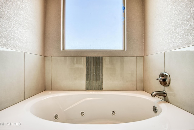 full bathroom with a jetted tub