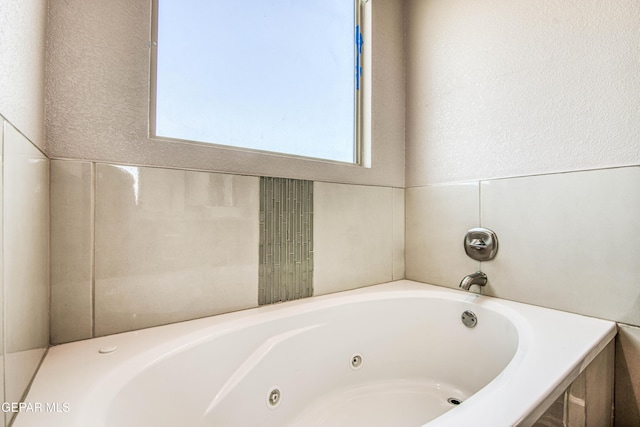 full bathroom featuring a whirlpool tub